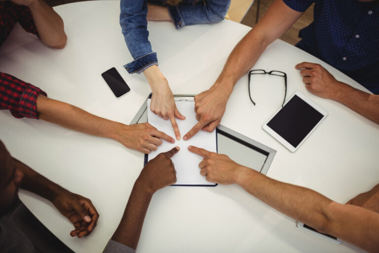 Business executives pointing on clipboard